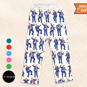 May include: White pajama pants with a repeating pattern of a man in a blue suit with a red tie dancing. The text "Great Gift" is in the upper right corner of the image.