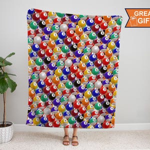 May include: A blanket featuring a repeating pattern of colorful billiard balls, each with a number from 1 to 15. The balls are in various colors, including red, yellow, blue, and green. The blanket is a great gift.