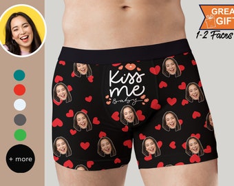 May include: Black boxer shorts with a red heart and kiss me baby print. The print features multiple faces.