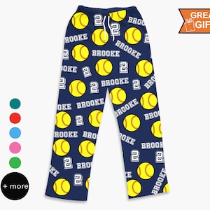 May include: Blue pajama pants with a repeating pattern of yellow softball with the number 2 and the name Brooke.