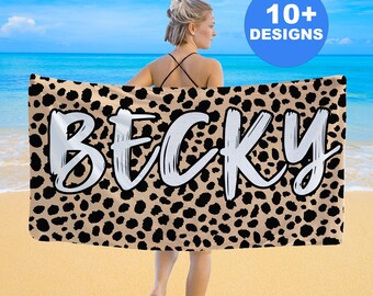 May include: A tan beach towel with a black and tan leopard print design. The name "Becky" is written in white across the towel.