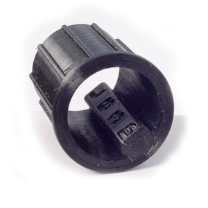 May include: Black plastic 3D printed ring with a textured surface and a hole in the center.