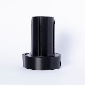 May include: Black plastic 3D printed adapter with a cylindrical shape and a round base.