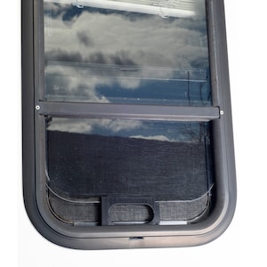 May include: A black framed window with a screen and a white blind. The window is open and the screen is visible. The blind is closed and the slats are horizontal.