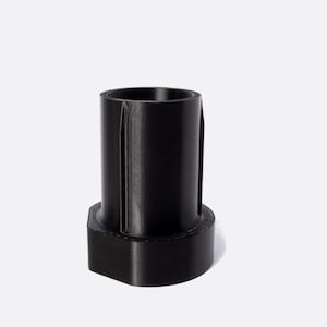 May include: Black plastic adapter with a cylindrical shape and a hexagonal base.