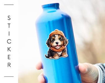 May include: A blue water bottle with a sticker of a puppy wearing a hat and scarf. The sticker is on the front of the bottle. The text "BarkRebels" is in the upper left corner. The words "STICKER" and "LAMINATED VINYL STICKERS" are on the left side.