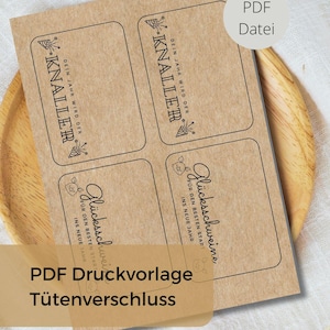 May include: A sheet of kraft paper labels with black text and illustrations. The labels are rectangular with rounded corners. Text includes "KNALLER" and "Glücksschweine" with additional phrases. The image also includes the text "PDF Druckvorlage Tütenverschluss".