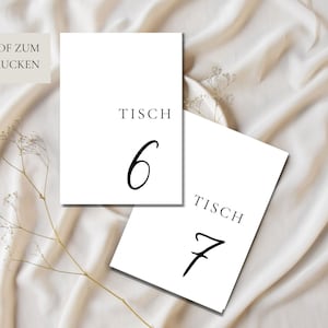May include: Two white cards with black text. The top card says "Tisch 6" and the bottom card says "Tisch 7".