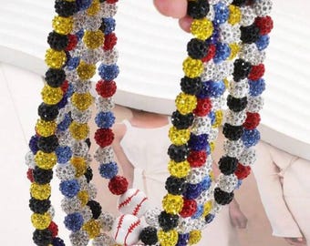 May include: A multi-strand necklace with sparkling beads in black, yellow, red, blue, and silver. Baseball-themed pendants are interspersed throughout the necklace, adding a sporty touch.