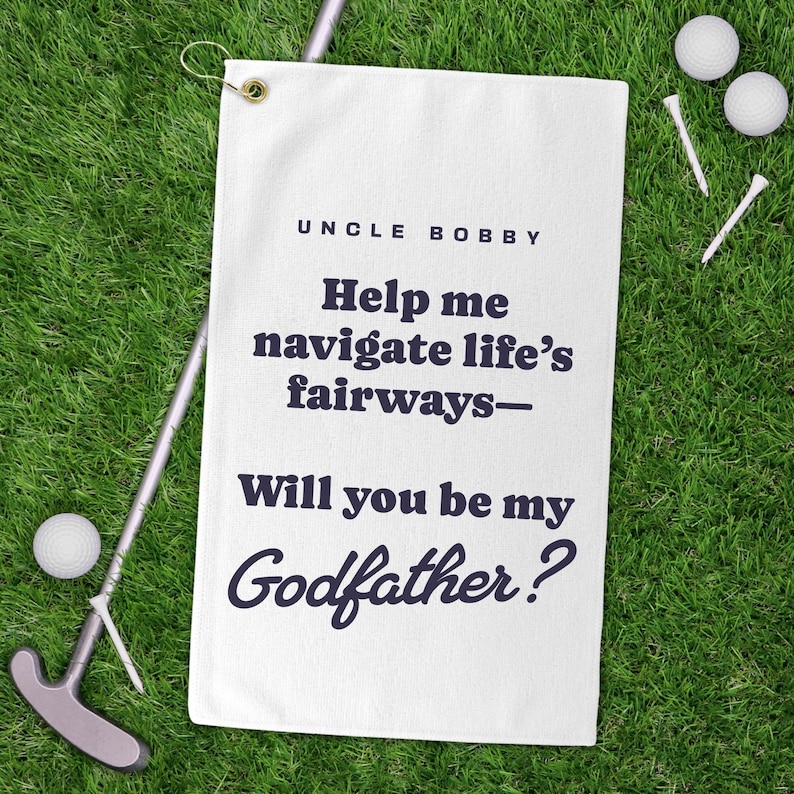 May include: White golf towel with the text "Uncle Bobby Help me navigate life's fairways - Will you be my Godfather?" printed in black.