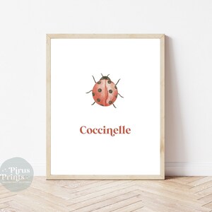 May include: A printable art print featuring a watercolor illustration of a ladybug with black spots on a red body. The word "Coccinelle" is written in red below the ladybug.