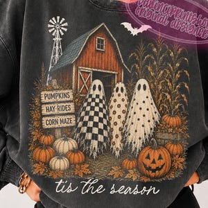 May include: A charcoal grey crewneck sweatshirt featuring a graphic of a red barn, a windmill, corn stalks, and three ghosts. The design includes text reading PUMPKINS, HAY-RIDES, CORN MAZE, and tis the season, surrounded by orange pumpkins.
