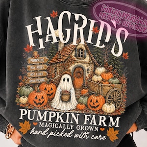 May include: A charcoal grey crewneck sweatshirt featuring a graphic print of a rustic cottage, a ghost holding a basket, and pumpkins. The text reads: HAGRID'S PUMPKIN FARM, MAGICALLY GROWN, hand picked with care, along with a sign listing PUMPKINS, HAY RIDES, HOT CIDER, and APPLE PICKING.