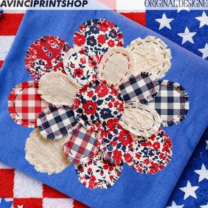 May include: A blue cushion featuring a flower design made from red, white, and blue fabric patches. The patches include floral prints, gingham, and linen-like textures. The text "DAVINCIPRINTSHOP" and "ORIGINAL DESIGNER" are visible.