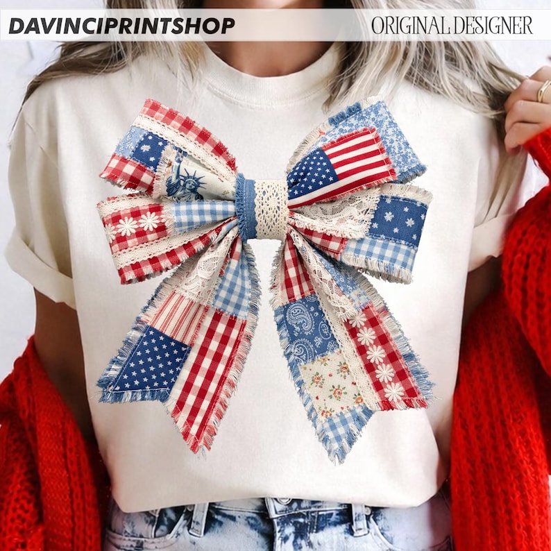 May include: White t-shirt featuring a large bow design with a patchwork pattern in red, white, and blue. The bow incorporates American flag elements, floral patterns, and lace details. The text "DAVINCIPRINTSHOP" and "ORIGINAL DESIGNER" are visible.