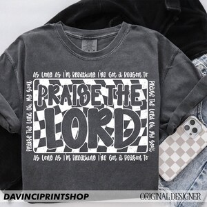 May include: A gray t-shirt with a white checkered design and the text "Praise The Lord Oh, My Soul" and "As Long As I'm Breathing I've Got a Reason To" on the front.
