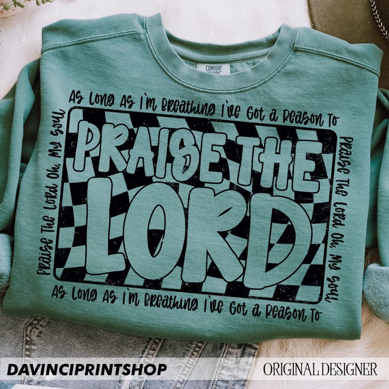 May include: Teal sweatshirt with a black and white checkered design and the text "Praise The Lord Oh, My Soul" and "As Long As I'm Breathing I've Got a Reason To Praise The Lord Oh, My Soul".