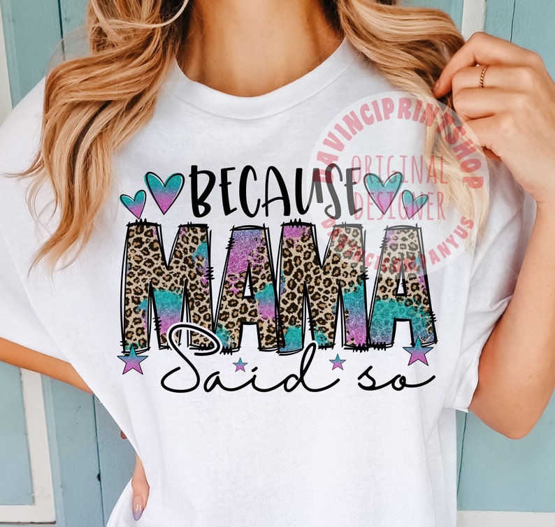 May include: White t-shirt with the text "Because Mama said so" in pink, blue, and black with a leopard print background. The text is surrounded by hearts and stars.