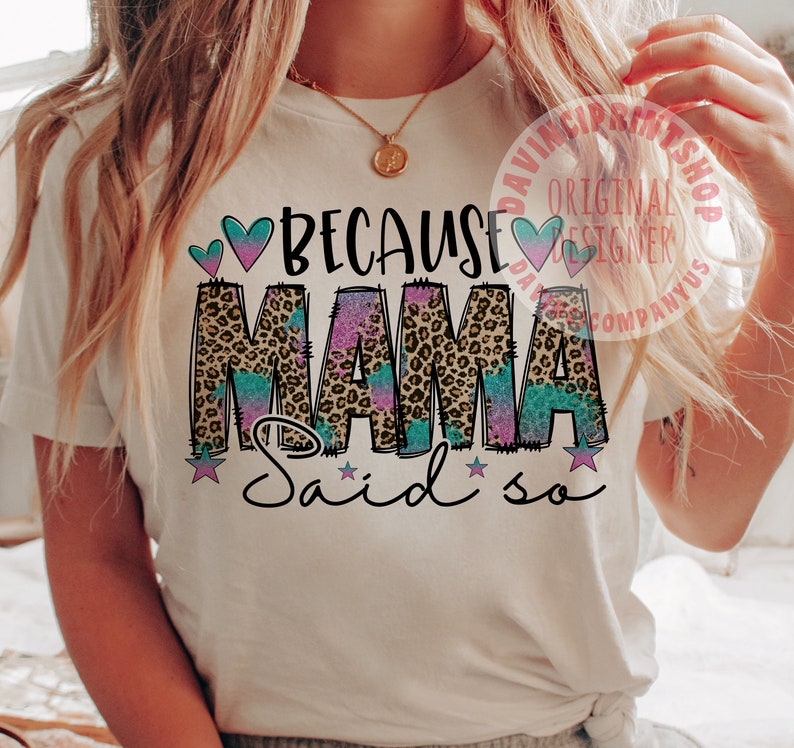 May include: White t-shirt with the text "Because Mama Said So" in pink, blue, and brown with a leopard print design.