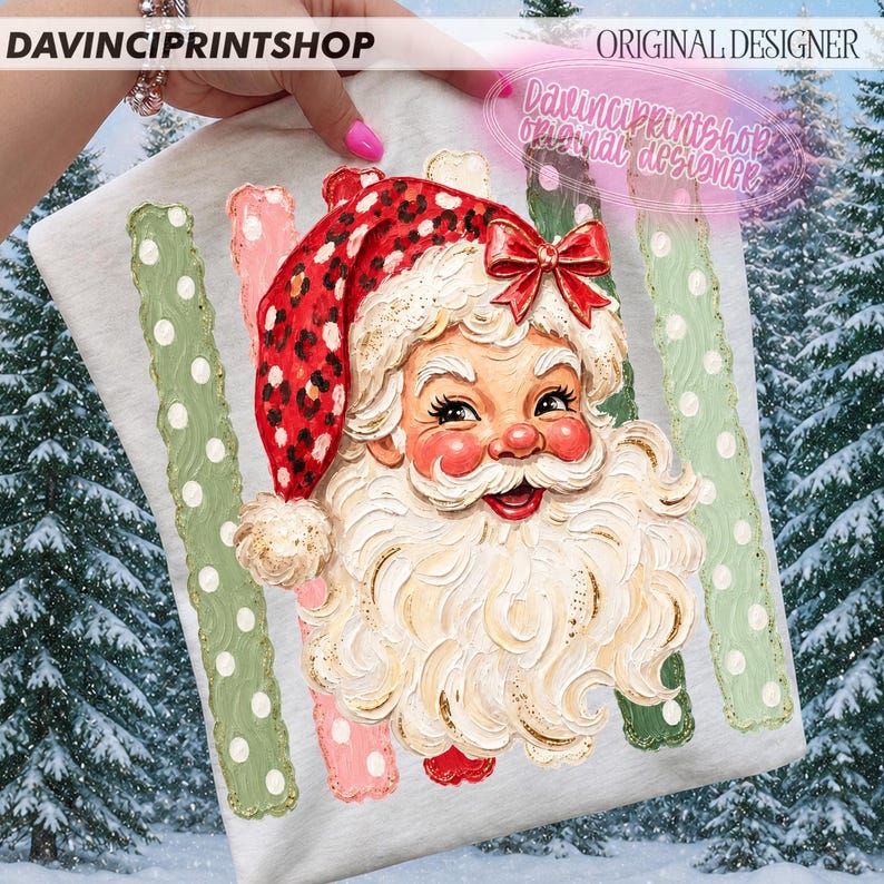May include: A light gray t-shirt featuring a graphic of Santa Claus with a white beard and a red leopard print hat with a red bow. The design is flanked by vertical green stripes with white polka dots and the text DAVINCIPRINTSHOP ORIGINAL DESIGNER.