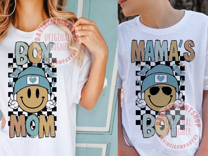 May include: Two white t-shirts with a chequered background and a smiling face wearing a beanie and sunglasses. The text on the shirts reads "Boy Mom" and "Mama's Boy".