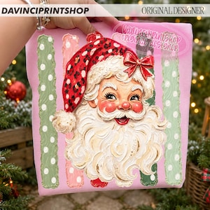 May include: A pink fabric panel featuring a central illustration of Santa Claus with a red leopard print hat and a red bow. The design includes vertical stripes in light green and pink with white polka dots and the text DAVINCPRINTSHOP.