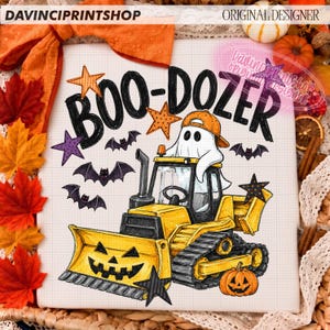 May include: A white square graphic featuring a yellow bulldozer with a jack-o'-lantern face, driven by a white ghost wearing an orange baseball cap. The text BOO-DOZER is written in black above the vehicle, surrounded by purple and orange stars and bats.
