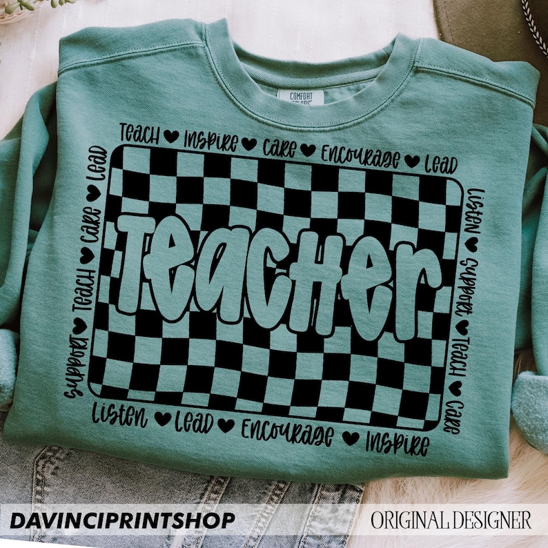 May include: Teal blue sweatshirt with a black and white checkered design and the word "Teacher" in a teal blue font. The words "Teach, Inspire, Care, Encourage, Lead, Listen, Support, Teach, Care" are written around the checkered design.