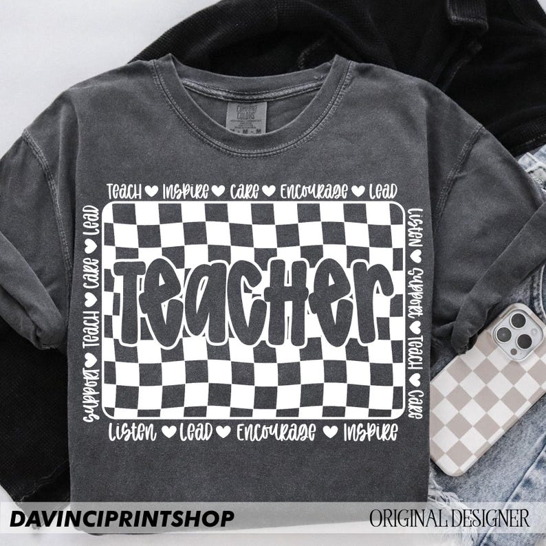 May include: A gray t-shirt with a black and white checkered design and the word "Teacher" in white text. The words "Teach, Inspire, Care, Encourage, Lead, Listen, Support, Teach, Care, Listen, Lead, Encourage, Inspire" are written around the checkered design.