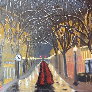May include: A painting of a snowy city street at night. The street is lined with trees and buildings. The streetlights are on and the snow is falling. The painting is done in a realistic style.