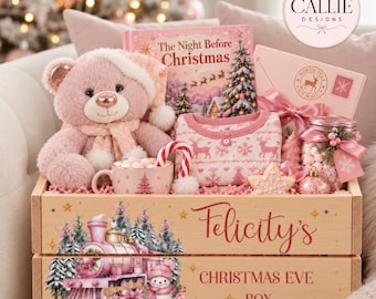 May include: A wooden Christmas Eve box labelled Felicity's Christmas Eve Box with a train illustration, containing a pink teddy bear, a copy of The Night Before Christmas book, pink pyjamas, a mug with marshmallows, a candy cane, and a gift box.