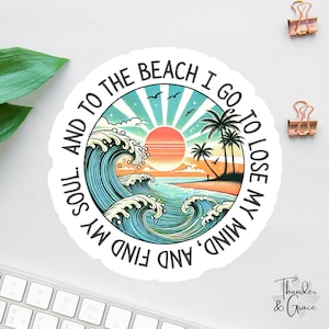 May include: A circular sticker with a beach theme. It depicts a sunset, ocean waves, palm trees, and the words "And to the beach I go to lose my mind, and find my soul." The sticker has a white border and is on a white surface.