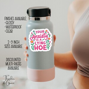 a woman holding a water bottle with a sticker on it