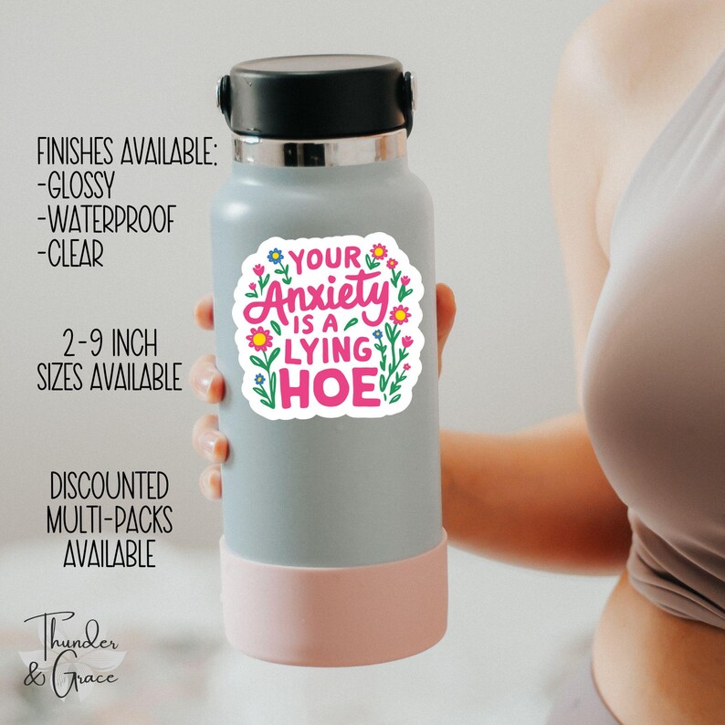 a woman holding a water bottle with a sticker on it