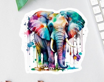 May include: A colorful watercolor painting of an elephant with a white background. The elephant is painted in shades of blue, green, purple, pink, and yellow. The painting has a splattered effect, as if the paint was dropped onto the paper.