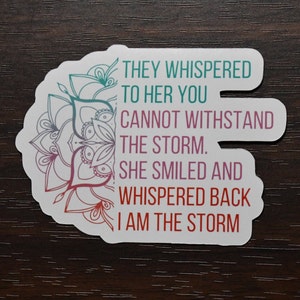 Puede incluir: Pegatina blanca con un diseño de mandala y el texto "They whispered to her you cannot withstand the storm. She smiled and whispered back I am the storm."