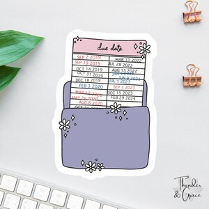 May include: A sticker depicting a purple file folder with a pink top labelled "due date." The file contains a list of dates. White flower and diamond accents decorate the sticker. The text "Thunder & Grace" is in the bottom right corner.