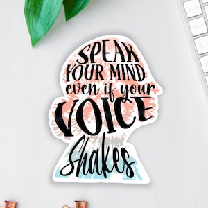 Può includere: Un adesivo con uno sfondo tie-dye e il testo "Speak your mind even if your voice shakes."