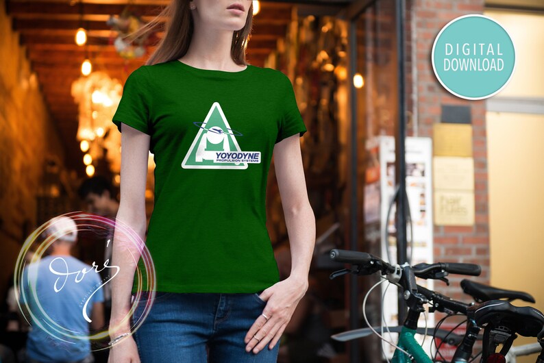 May include: A green t-shirt with a white triangle graphic featuring a stylized spaceship and the text "YOYODYNE PROPULSION SYSTEMS".