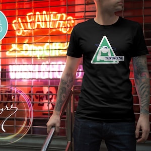 May include: A black t-shirt with a green triangle graphic featuring a white figure and the text "YOYODYNE PROPULSION SYSTEMS".
