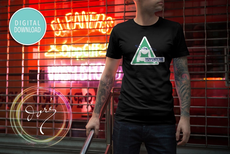 May include: A black t-shirt with a green triangle graphic featuring a white figure and the text "YOYODYNE PROPULSION SYSTEMS".