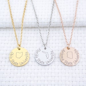 May include: Three gold, silver, and rose gold necklaces with round pendants featuring the state outlines and names of Ohio State University, Florida State University, and Arizona State University.