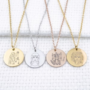 May include: Four silver necklaces with round pendants featuring different engraved images of women. The necklaces are on a white fabric background.