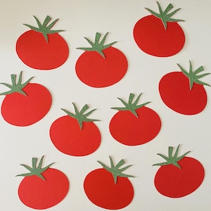 May include: Nine red paper tomatoes with green glittery stems are arranged on a white background. The tomatoes are evenly spaced and appear to be cut-out shapes. The image is a flat lay, with the tomatoes facing upwards.