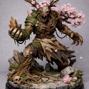 May include: A detailed fantasy sculpture of a tree-like creature with antlers adorned with pink blossoms. The figure has a wooden texture, green accents, and a skull-like face with a red eye. It stands on a rocky base with a skull and pink flowers.