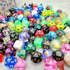 May include: A large collection of colorful, multi-sided dice with various patterns and designs. The dice are made of different materials, including plastic, glass, and metal. Some of the dice have gold accents.