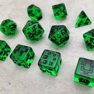 May include: Set of ten green dice with black markings. The dice are translucent and have different shapes and sizes. Some dice have numbers, while others have pixelated images of a creeper face.