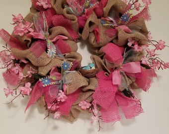 Pink and tan burlap wreath with bird in nest