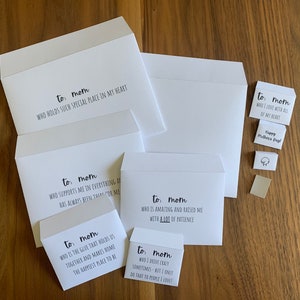 May include: A collection of white envelopes in various sizes, each printed with black text addressed to mom. The messages include phrases like who holds such special place in my heart, who is amazing and raised me with a lot of patience, and happy mother's day.