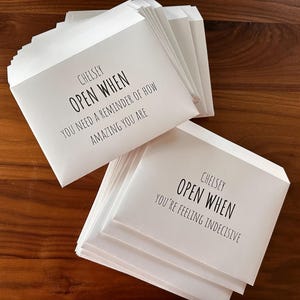 May include: A stack of white envelopes with the text "CHELSEY OPEN WHEN YOU NEED A REMINDER OF HOW AMAZING YOU ARE" on the top envelope and "CHELSEY OPEN WHEN YOU'RE FEELING INDECISIVE" on the bottom envelope.